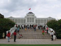 Istana building in Singapore with palm trees and a flagpole