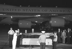 President William Jefferson Clinton attending repatriation ceremony at Noi Bai International Airport with American flag draped casket of Vietnam War soldiers