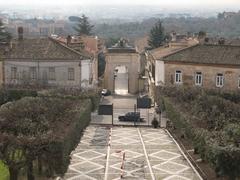 Rear view of the Arco Borbonico arched gate and entry garden at Palazzo del Belvedere in San Leucio, Campania