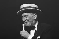 Maurice Chevalier performing farewell show at Concertgebouw Amsterdam wearing straw hat black and white photo