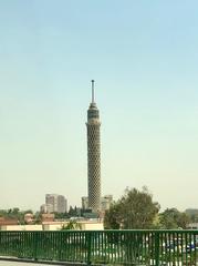Cairo Tower standing tall on Geizera Island in the middle of the Nile River with the city skyline in the background