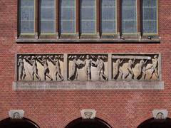 Decorative facade stone with inscription at Beursplein in Amsterdam, Netherlands