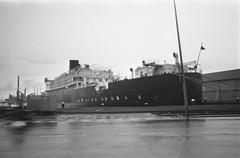 Black and white photo of the student ship Caledonia temporarily docked at Stenen Hoofd in Amsterdam in December 1967