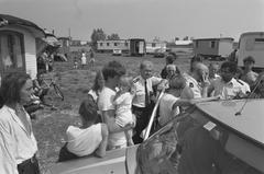 Police officers talking with residents at a caravan camp in Amsterdam during a canceled eviction on June 14, 1989