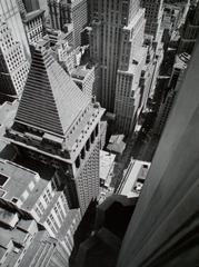 View of Wall Street from roof of Irving Trust Building showing pyramidal roof and Customs House