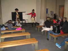 2015 Evacuation Day Commemoration event at historic Federal Hall with reenactors and audience