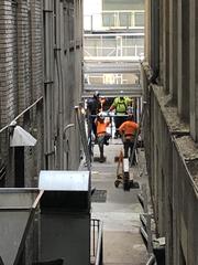 Alleyway looking south with utility poles and pathways between buildings