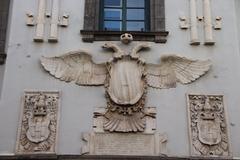 Eagle statue on top of a historic building in Naples, Italy under a clear blue sky
