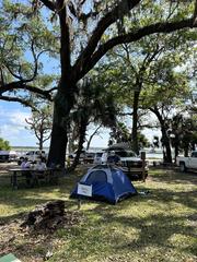 Blue camping tent under trees near parking lot at 7 Creeks Fest Camping Clinic