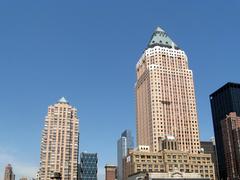 South side view of One Worldwide Plaza building with Hearst Tower and Random House Tower in background on a spring afternoon