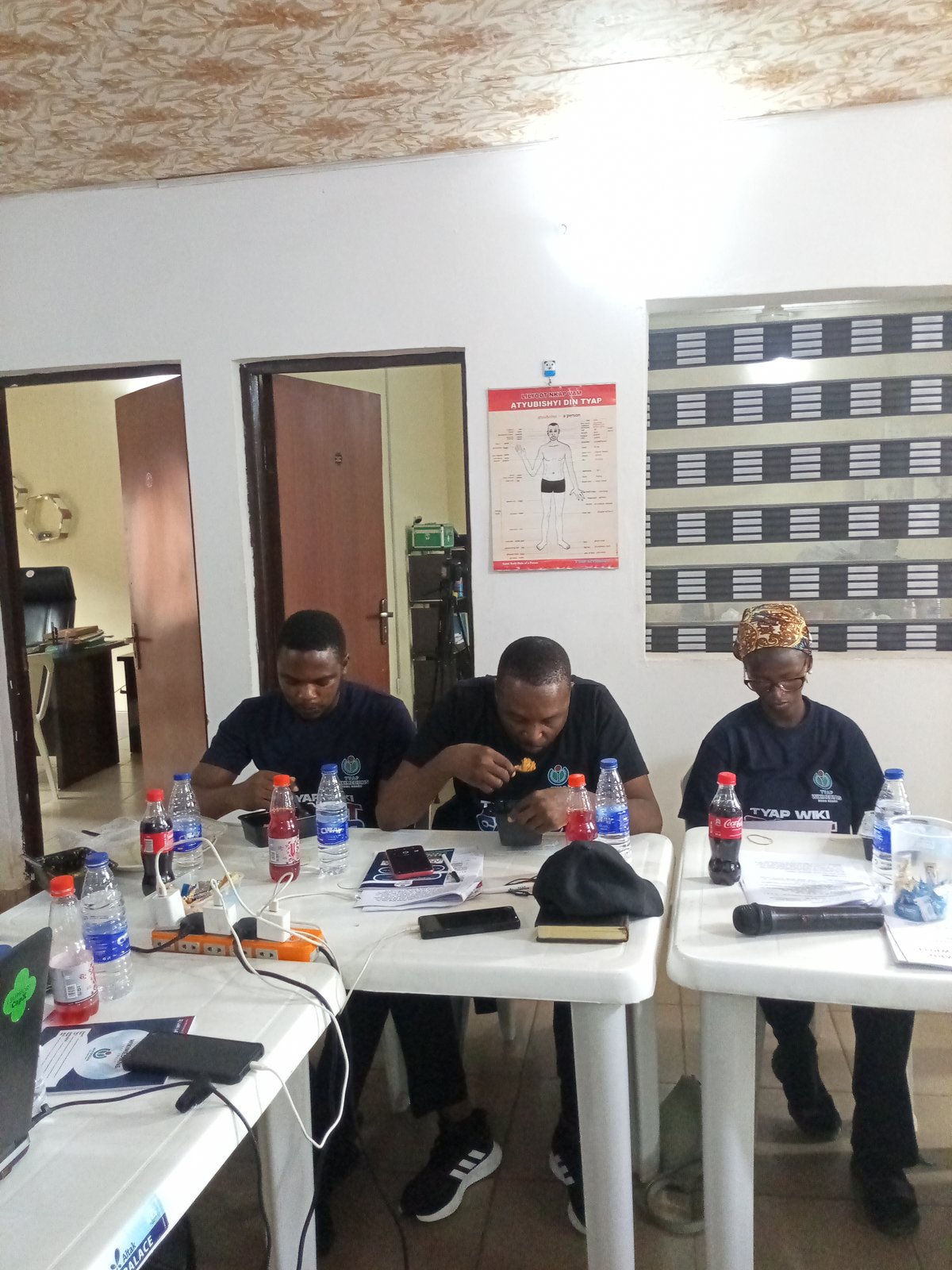 Participants involved in a collaborative photo shoot at the Tyap Wiki Bootcamp season 2 in-person meeting