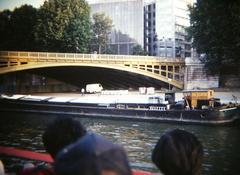 Seine River barge cruising in Paris with cityscape in background