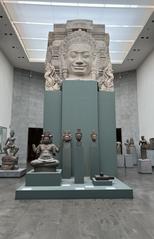 Interior view of a gallery room at the Musée Guimet in Paris with classical statues and artworks