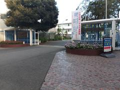 Gate entrance of Showa Women's University with a brick wall and greenery