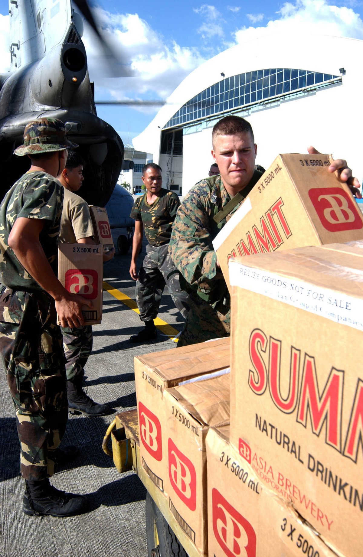 U.S. Marine Corps Lance Cpl. Jesse M. Ford loading bottled water onto CH-46E Sea Knight helicopter