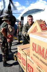 U.S. Marine Corps Lance Cpl. Jesse M. Ford loading bottled water onto CH-46E Sea Knight helicopter