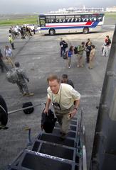 Bob R. McCluskey Jr. boarding U.S. Air Force C-17 Globemaster III at Manila International Airport