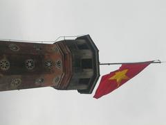Exterior view of the Army Museum in Hanoi in 2003 with flags and red banners