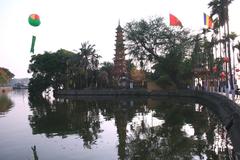 Chùa Trấn Quốc temple in Hanoi Vietnam reflecting on the water at sunset