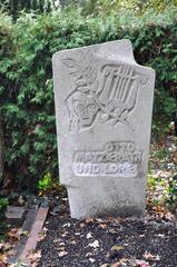 Tombstone of Otto Matzerath with engraved text and greenery around
