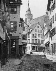Historic view of Neckargasse street in Tübingen around 1878 with traditional buildings and cobblestone road