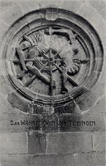 Landmark of Tübingen at the Stiftskirche showing the wheels of Saint George ornament on the north wall of the church