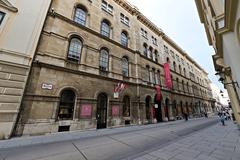 Street view of Herrengasse in Vienna with historic buildings and clear skies