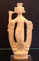 Small bronze sculpture resembling a figure, possibly representing a historic or ancient artifact