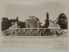 Fountain in Munich featuring mythical figures riding horses and bulls with water spouts along the base