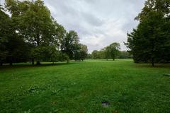 Grüneburgpark in Frankfurt am Main with green trees and walking paths on a sunny day