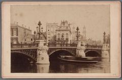 New stone Blauwbrug bridge over the Amstel river in Amsterdam with Waterlooplein and Mozes- en Aäronkerk in view