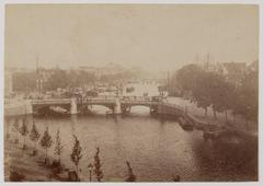 View of the Amstel River with the historic Blauwbrug bridge in Amsterdam, seen towards the south