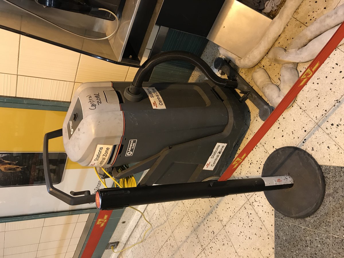 Advance VL500 wet dry vacuum being used near payphones at Yonge Subway Station eastbound platform Toronto
