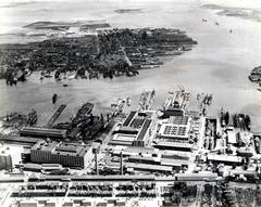 Aerial view of the Boston Navy Yard in 1942 showing destroyers, destroyer escorts, USS Constitution, and Jeffrey Field