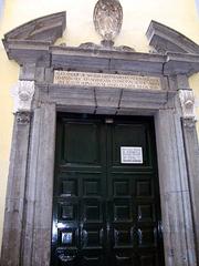 Entrance of Cappella Sansevero in Naples Italy with ornate stone archway and detailed sculptures