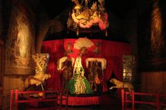 Interior decor of the Musée des Arts forains showcasing vintage fairground art and vibrant lighting