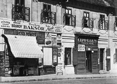 Historical building at 1-3 Apród utca, birthplace of Ignác Semmelweis, Budapest between 1931-1935 with vintage grocery store advertisements