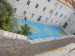 Basketball court on the terrace of a building in Dubrovnik Old Town next to historic fortified walls