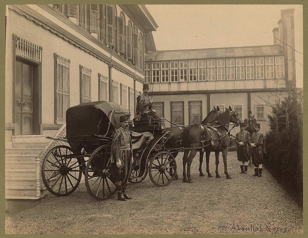 Men in uniform with horse drawn carriage in front of Yıldız Palace Istanbul