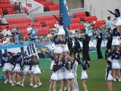 Kinki University cheerleading team performing at Hanazono Rugby Stadium in June 2024