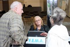 Visitors speak with Individual Assistance Specialist at FEMA community resource festival in Texas after Hurricane Ike