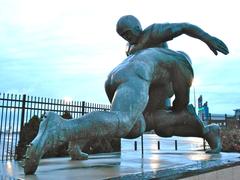 Bronze sculpture titled 'Tackle' by Joe Brown, installed at Veterans Stadium and later moved to Citizens Bank Park