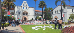 Pro-Palestinian protesters at San Diego State University holding signs and posing for photos on April 30, 2024