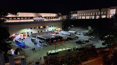 Queens of the Stone Age tour trucks parked at Viejas Arena loading area with old Aztec Bowl bleachers in the background