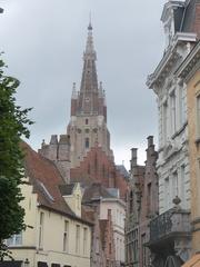 Scenic view of historic Bruges cityscape with canals and medieval buildings at dusk