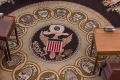 Center medallion of a large Senate Chamber carpet with an eagle and 13 state seals surrounding it