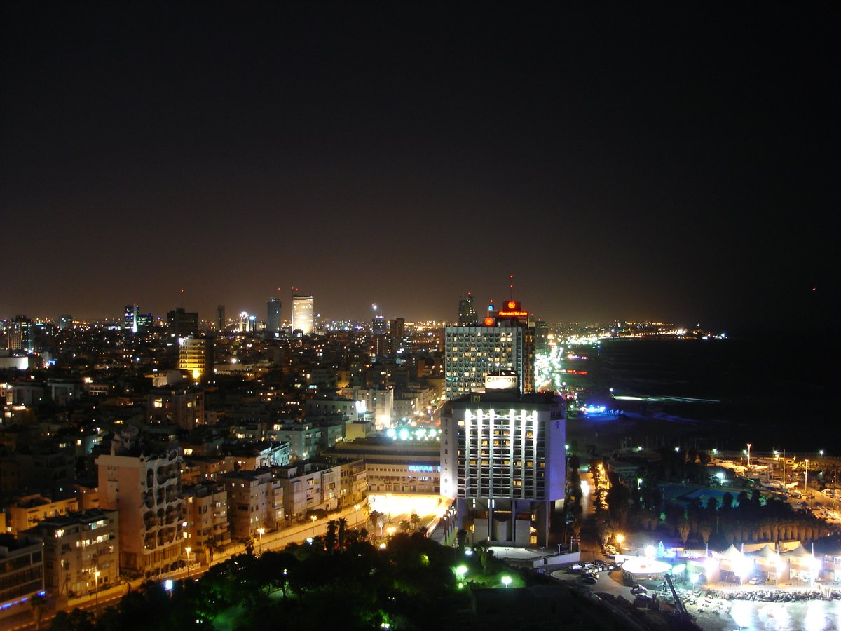 Night view of Tel Aviv coastline with marina and city lights