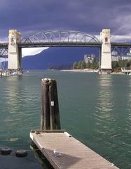 Burrard Bridge in Vancouver with city skyline and mountains in the background