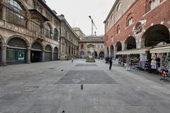 Dei Mercanti square in Milan with historic buildings and cobblestone pavement on a sunny day