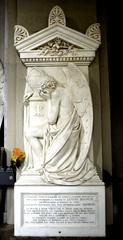 Funerary monument in Staglieno Cemetery featuring intricate sculptures and detailed artistry